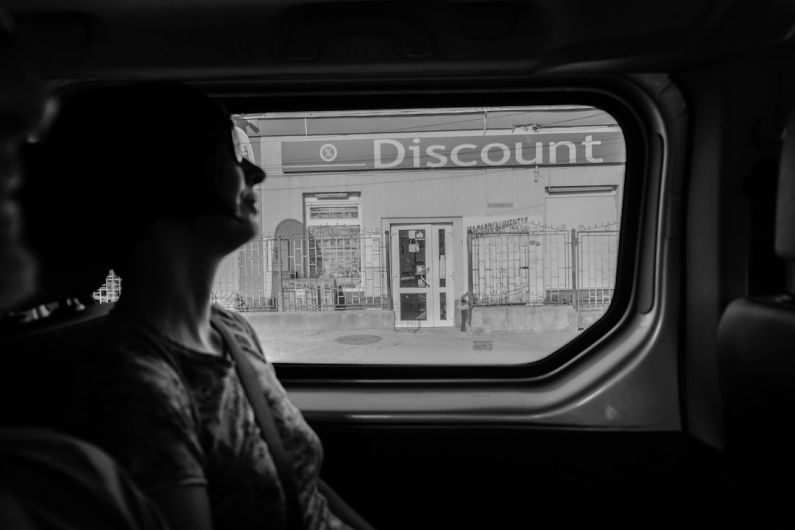 Discount Hunt - greyscale photography of woman inside vehicle