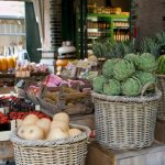 Vegan Shopping - a market with baskets of fruit