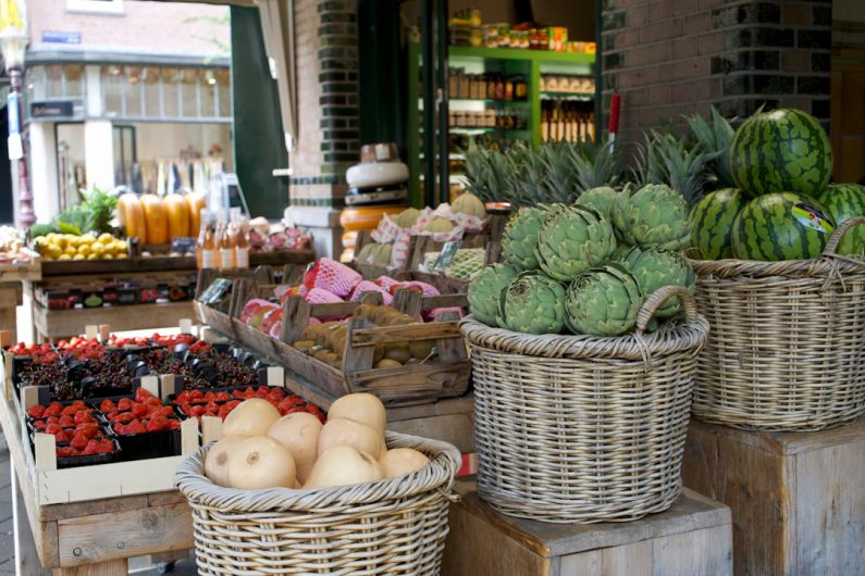 Vegan Shopping - a market with baskets of fruit