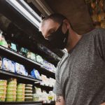 Cheap Groceries - man in gray crew neck t-shirt standing near shelf
