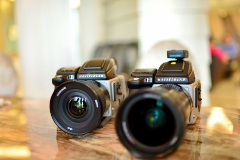 Electronics Favorite - a couple of cameras sitting on top of a wooden table