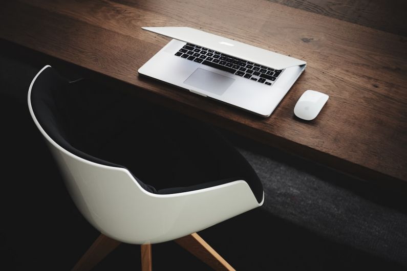 Tech Launch - Apple MacBook beside computer mouse on table