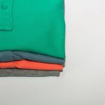 Size Guide - green polo shirt on white table
