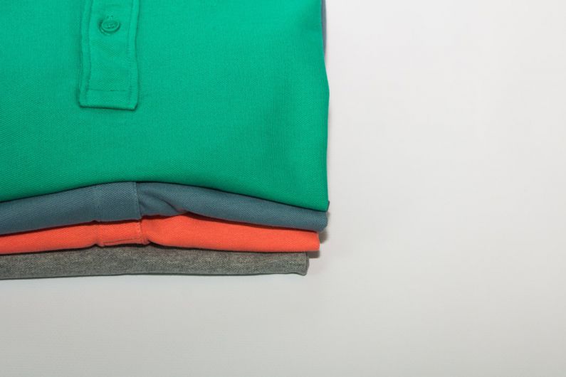 Size Guide - green polo shirt on white table