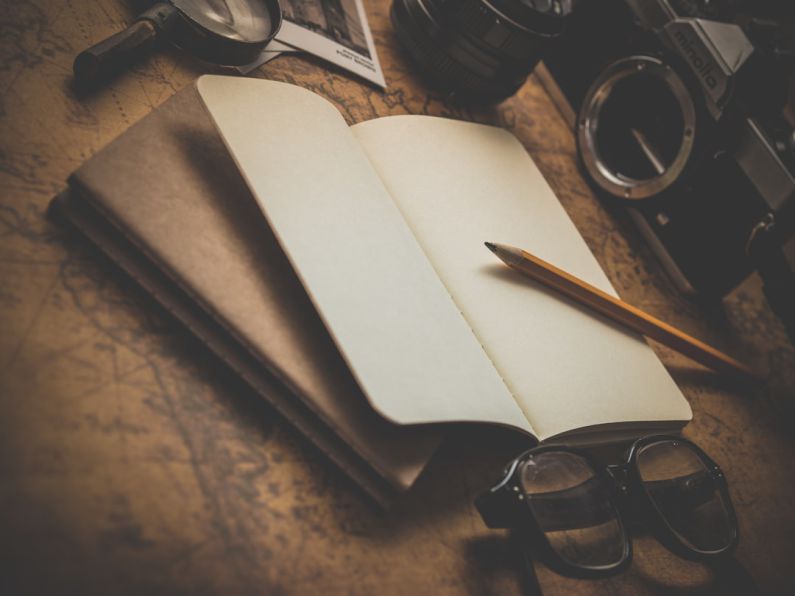 Camera Launch - brown pencil on white book beside black eyeglasses