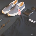 Men's Fashion - folded black Play shirt beside iPhone X, digital watch, and sneakers
