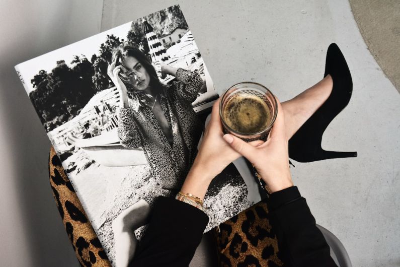 Luxury Fashion - woman holding clear glass candle holder and grayscale portrait of a woman