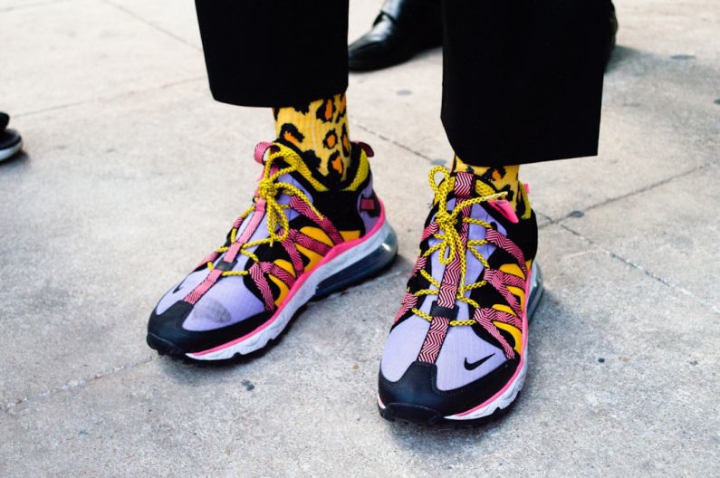 Street Style - person wearing black blue and yellow nike sneakers