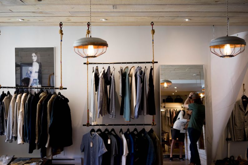 Fashion Technology - person leaning on wall while holding gray hat