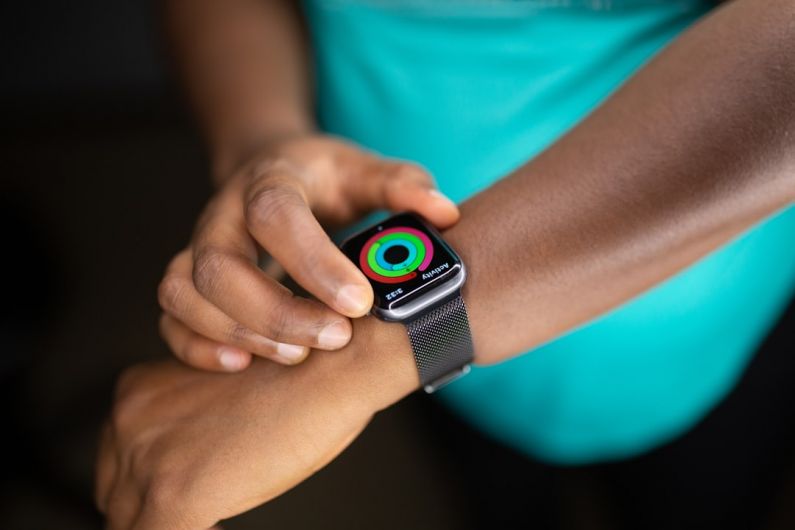 Wearable Technology - person wearing silver aluminum case apple watch with white sport band