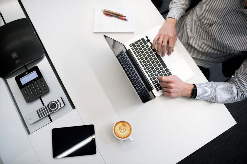 Budget Gift - person using laptop on white wooden table