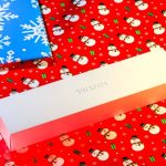 Fitness Gift - a white box sitting on top of a red wrapping paper
