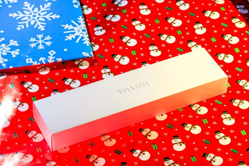 Fitness Gift - a white box sitting on top of a red wrapping paper