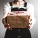 Quirky Gift - person showing brown gift box