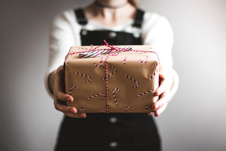 Quirky Gift - person showing brown gift box
