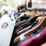 Eco Clothing - selective focus photography of hanged clothes