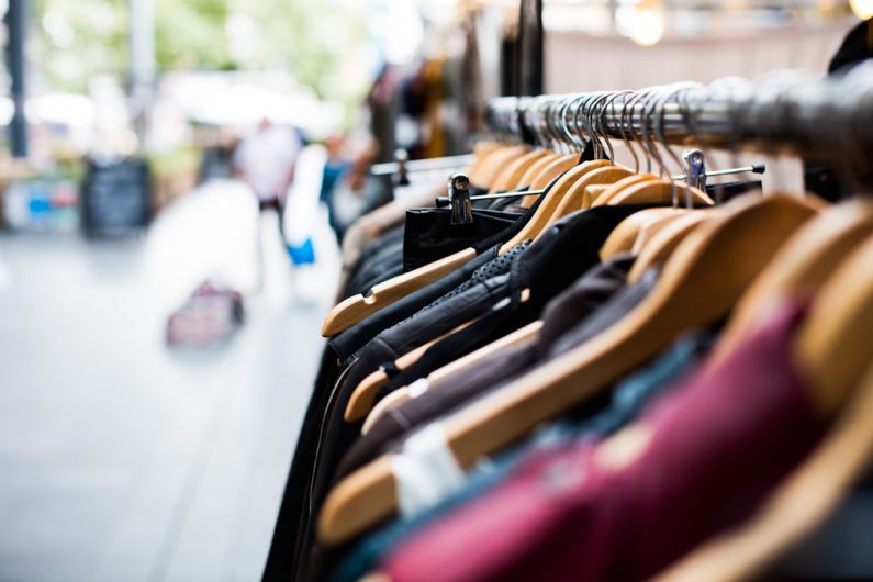 Eco Clothing - selective focus photography of hanged clothes