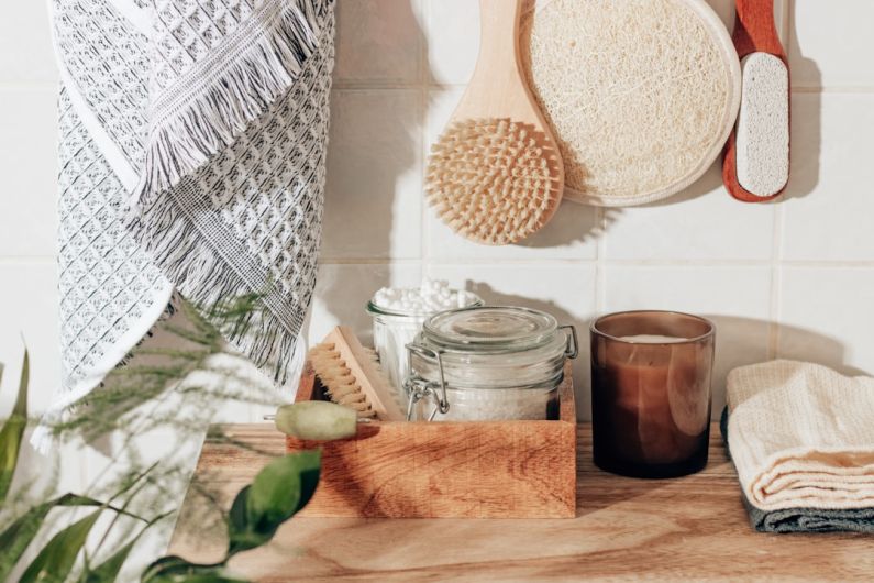 Sustainable Living - brown wooden chopping board beside clear glass jar