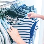 Sustainable Wardrobe - person holding white and black striped shirt